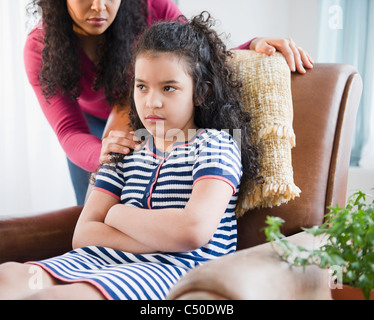 Stubborn mother and child girl sitting turned away on sofa Stock Photo ...