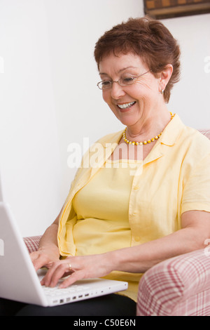 Senior Chilean woman typing on laptop Stock Photo