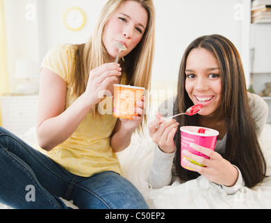 Teenage girls eating ice cream together Stock Photo