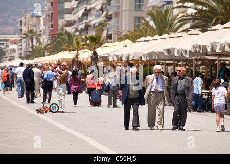 elderly man having a walk on waterfront promenade of the coastal port city Volos in Thessaly on the Greek mainland, Greece Stock Photo