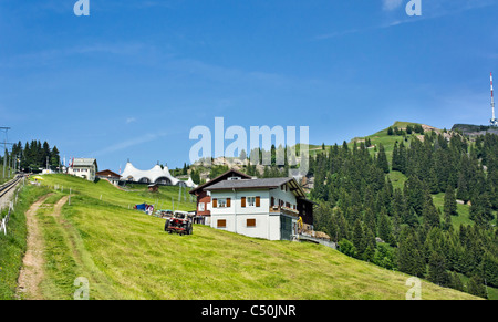 Railway station at Staffel on Rigi Mountain Switzerland with Rigi Event Tent and Rigi Kulm to the right with local farm in front Stock Photo