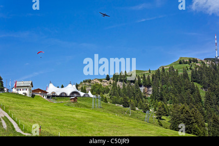 Railway station at Staffel on Rigi Mountain Switzerland with Rigi Event Tent and Rigi Kulm to the right & aeroplane and glider Stock Photo