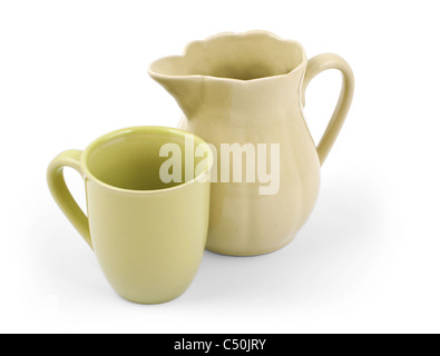 Old green ceramic pitcher and cup isolated on white background Stock Photo