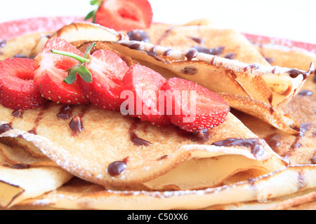 pancakes with strawberries on red plate Stock Photo