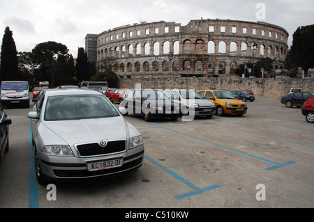 Carpark with parked cars in front of the Roman Amphitheater in Pula, Croatia. Stock Photo