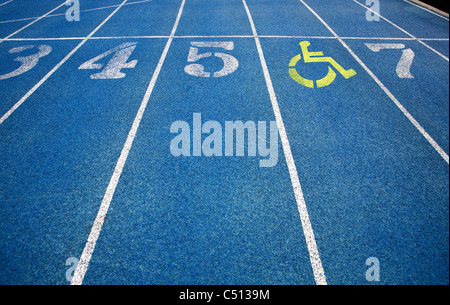 Handicap wheelchair icon superimposed on top of running track. Stock Photo