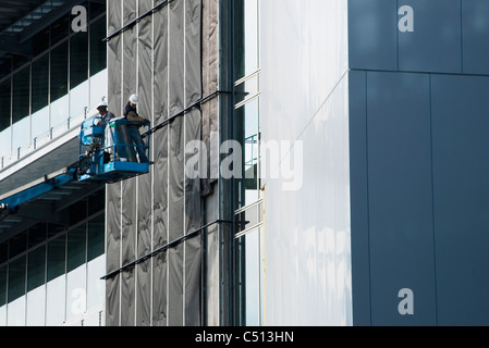 Construction workers in cherry picker Stock Photo