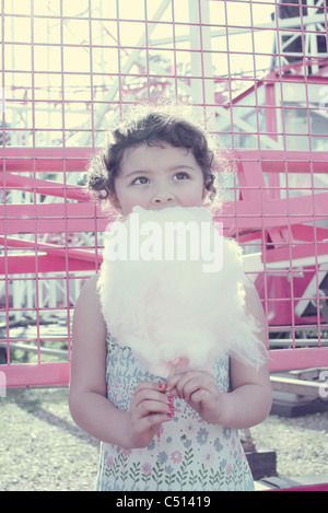 Little girl eating cotton candy Stock Photo