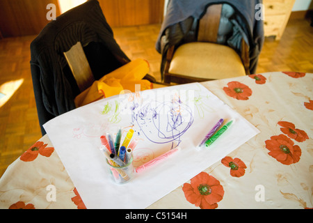 Child's drawing and color pens on table Stock Photo