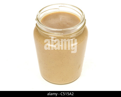 Full Glass Jar of Tasty Peanut Butter Against A White Background With Copy Space, A Clipping Path and No People Stock Photo