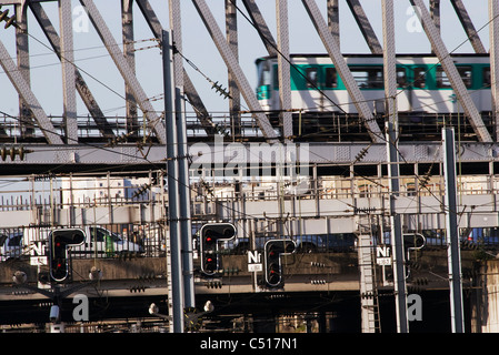 Subway train passing on bridge over city traffic Stock Photo