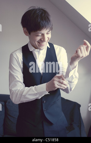 Man buttoning shirt cuff Stock Photo