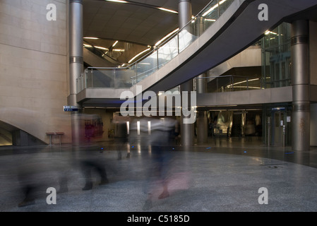 People walking through building atrium, blurred motion