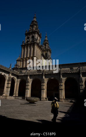 A tourist walks in the cloister of the Cathedral of Santiago de Compostela, Spain. Stock Photo