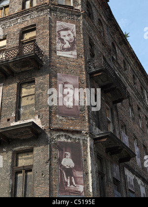 Photographs of occupants of the Jewish Ghetto in Warsaw, Poland, on the wall of a remaining building in ul Próżna. Stock Photo