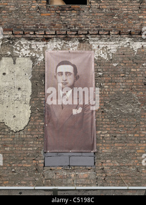 A photograph of an occupant of the Jewish Ghetto in Warsaw, Poland, on the wall of a remaining building in ul Próżna. Stock Photo