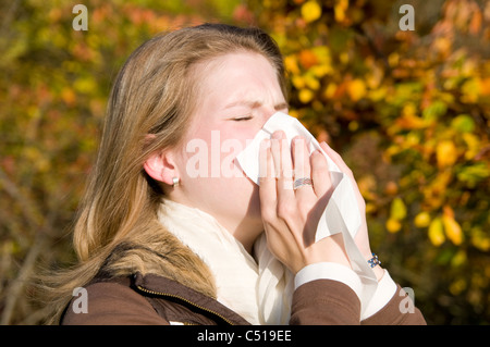Woman with a cold in autumn