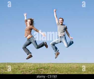 Couple jumping for joy, Jena, Thuringia, Germany, Europe Stock Photo