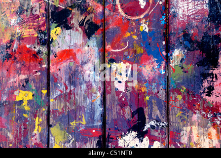 Paint splatters make an interesting pattern on the top of a picnic table. Stock Photo