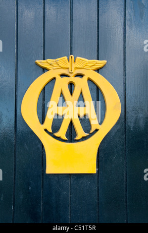 Yellow logo symbol of AA Automobile Association close-up (on box 442 -historic iconic roadside phone kiosk) - Aysgarth, North Yorkshire, England, UK. Stock Photo