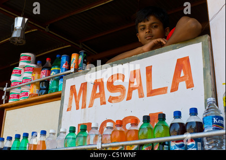 A young boy overlookin a family restaurant in Hami, Karnataka, India. Stock Photo