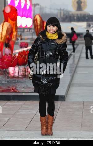 Young Asian Woman Standing Standing on The street with Holiday Decorations in The Background , Xian, China Stock Photo