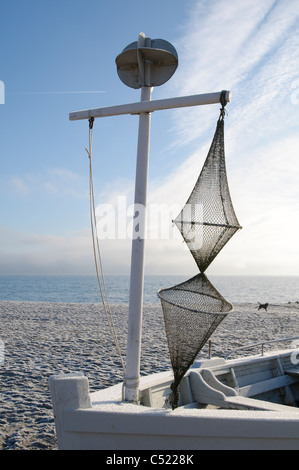 Boat with a fishing net on a beach in winter, Sierksdorf, Luebeck Bay, Baltic Sea, Schleswig-Holstein, Germany, Europe Stock Photo