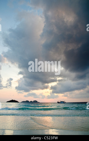 Boat at sunrise with cloud formation, Pulau Redang island, Malaysia, Southeast Asia Stock Photo