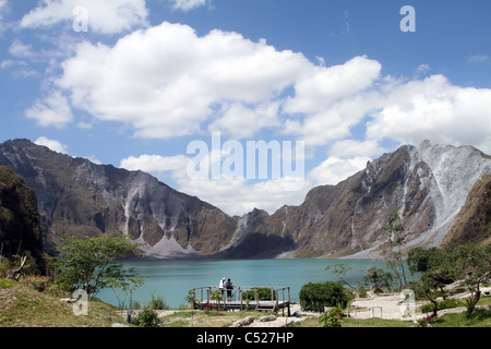 Two tourists view the scenic crater of Mt. Pinatubo in the island of Luzon in the Philippines. (People not recognizable.) Stock Photo
