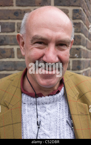 Young man in his late-fifties street portrait with moustache. Stock Photo