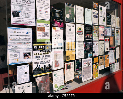 Posters and adverts in shop window Stock Photo