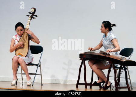 Chinese woman playing a Zheng or guzheng and a Chinese woman playing a Pipa Stock Photo