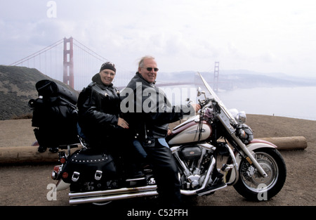 two senior citizensat Golden Gate Lookout on Harley Davidson motorcycle Stock Photo