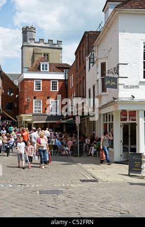 The Square in Winchester, Hampshire, England with historic building, shops and street cafes on a summer's day. Stock Photo
