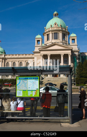 People at bus stop in Pionirski Park across from Serbian Parliament Assembly building Belgrade capital of Serbia Europe Stock Photo