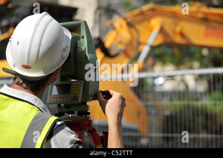 man using theodolite on building site Stock Photo