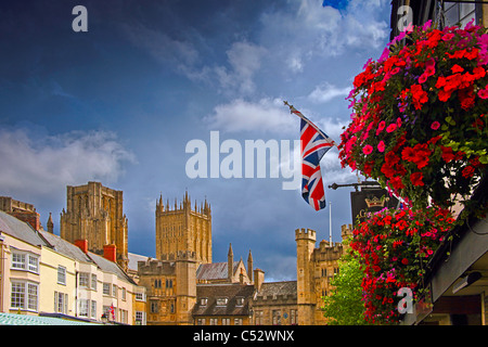 Colourful floral baskets outside the Crown Inn in the Market Place at Wells Somerset England UK Stock Photo