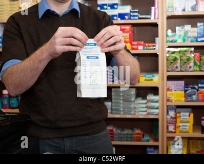 pharmacist handing over prescription at chemist