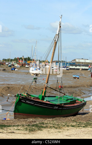 The cockle boat Endeavour, famous for rescuing troops from Dunkirk in 1940, moored at Leigh against a backdrop of boatyards. Stock Photo