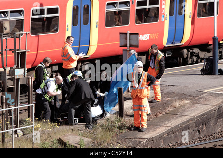 Undertakers recover the body of a suicide victim hit by a train at Clapham Junction Stock Photo