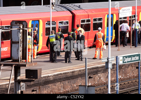 Undertakers recover the body of a suicide victim hit by a train at Clapham Junction Stock Photo