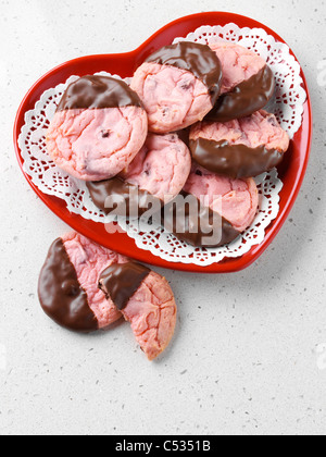Strawberry cookies dipped in chocolate Stock Photo
