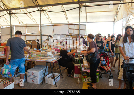 Seller and buyers at the market in Rosh HaAyin,  Israel. , שוק ראש העין, Stock Photo