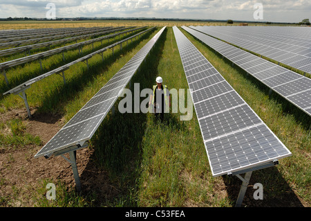 UKs first solar electric power station under construction at Fen Farm near Louth Lincolnshire and ecotricity wind farm behind Stock Photo