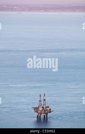 Aerial evening view of oil platform in Cook Inlet, Southcentral Alaska, Winter Stock Photo