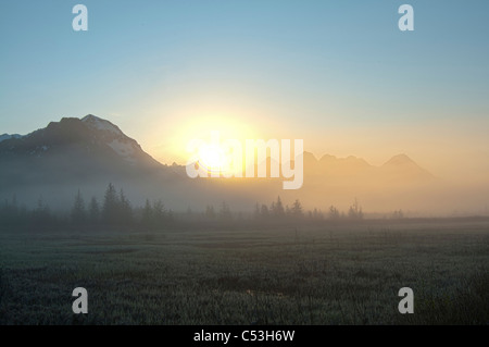 Morning fog hangs on the ground near the Copper River Highway, sunrise, Chugach Mountains, Chugach National Forest, Alaska Stock Photo