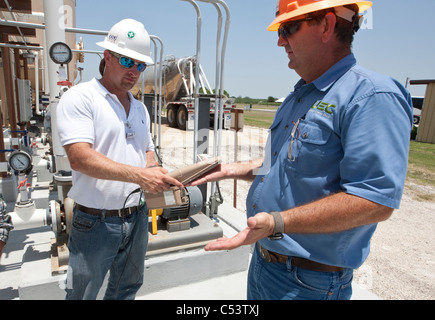 safety officer uses an Alpha detector used to scan worker for possible elevated radiation at an Uranium processing plant Stock Photo