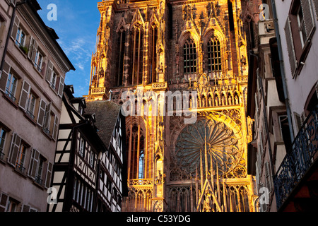 Setting sun shines on the massive Cathedral Notre Dame in Strasbourg, Bas-Rhin, Alsace, France Stock Photo
