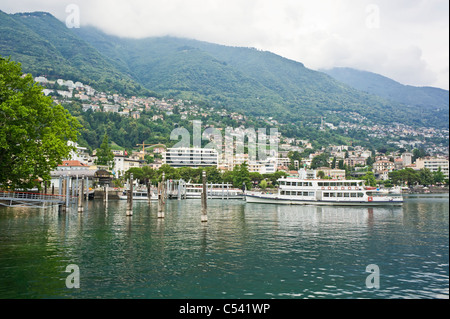 Locarno in Switzerland from the shores of Lago Maggiore with cruise vessel Milano leaving the berth Stock Photo