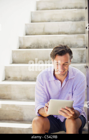Mid adult man using a digital tablet Stock Photo